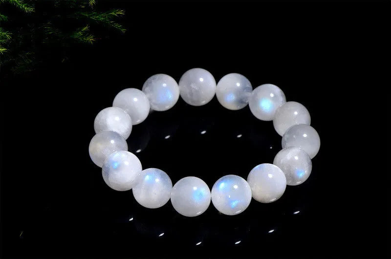 Natural blue moonstone round bead bracelet with white accents showing polished stone surface