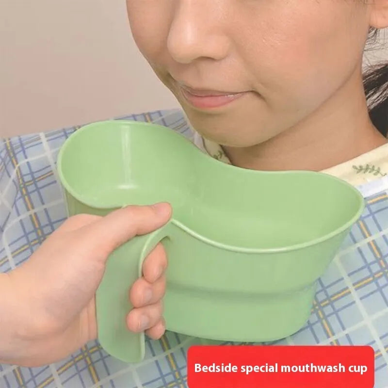 Green plastic gargle cup for bedridden patient oral care on bedside table