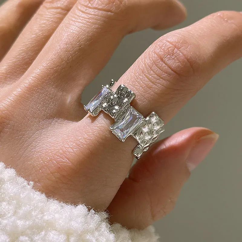 Silver geometric cross ring with open zircon stone setting and retro design
