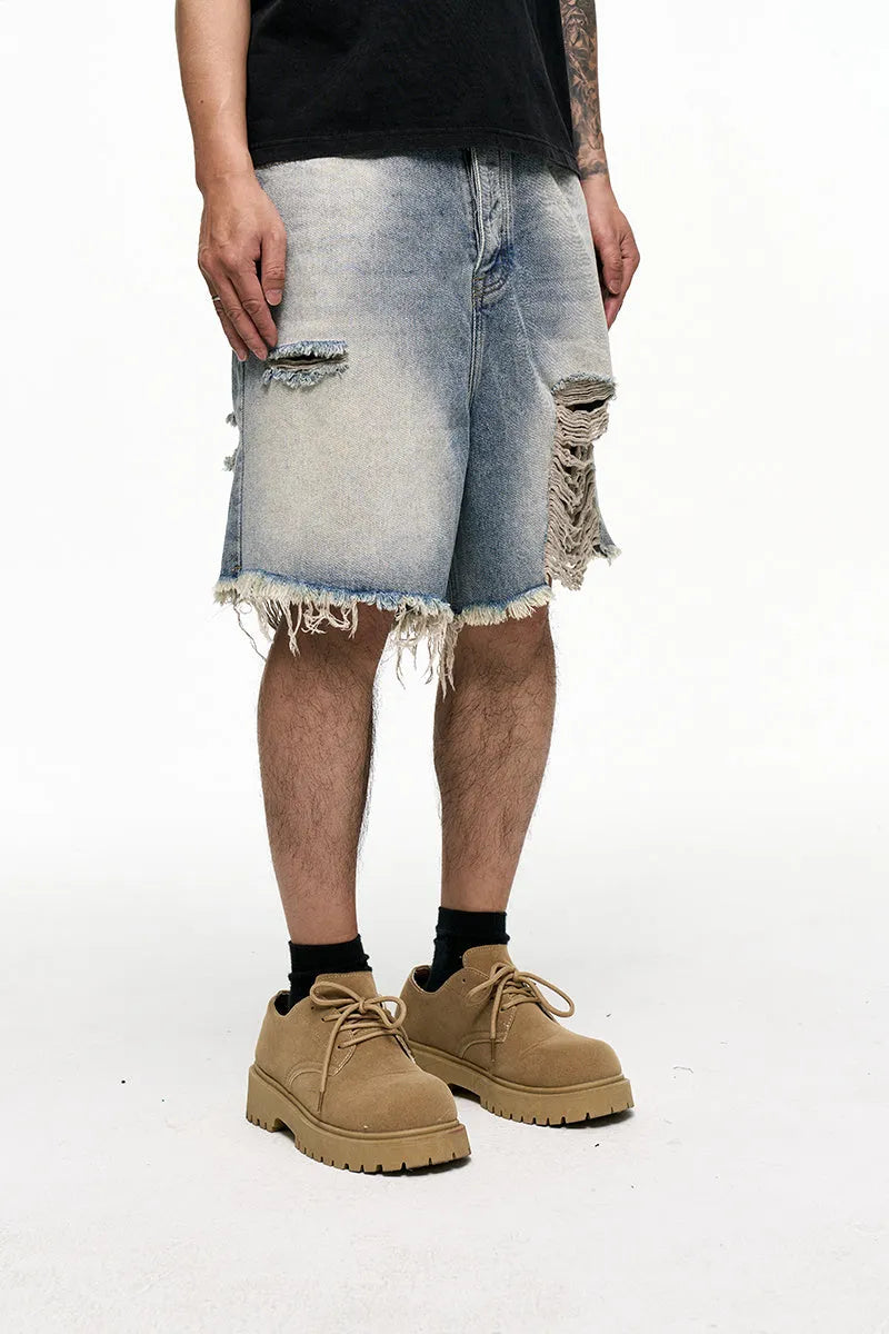 Light blue men's baggy denim shorts with a wide leg and retro washed finish on a mid-waist.