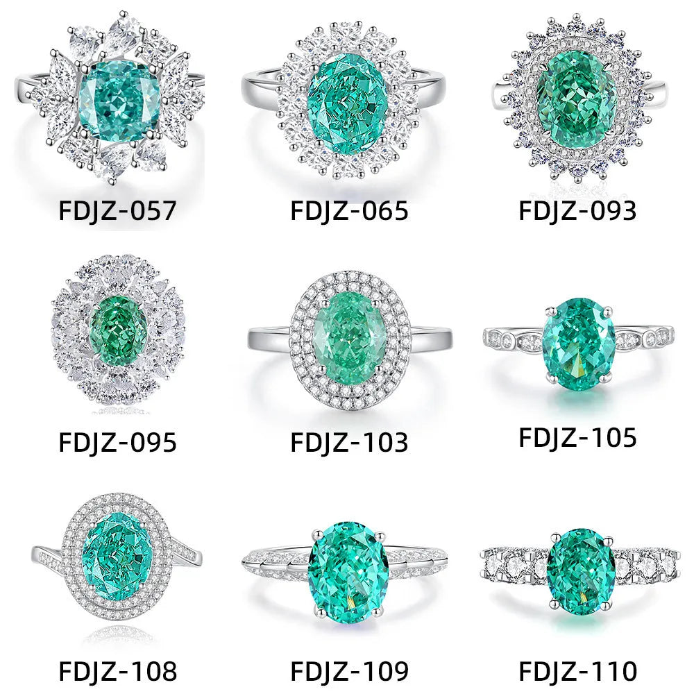 Women's oval emerald and diamond ring in sterling silver on a hand.