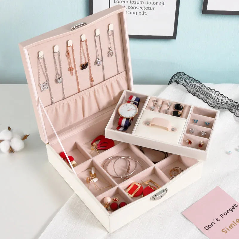 Red large capacity PU jewelry storage box open to show compartments for necklaces, rings, and earrings.