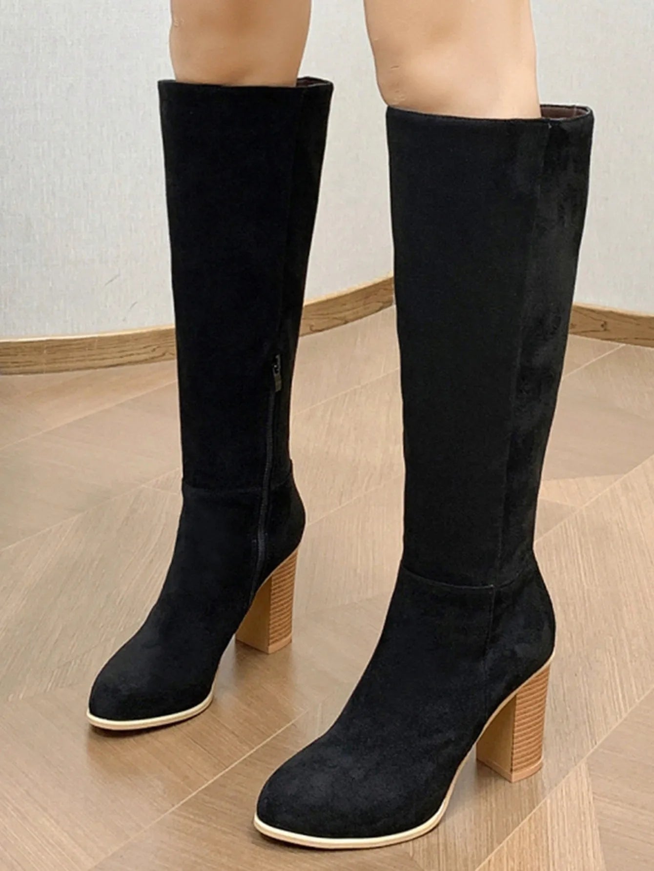 Women's black square toe high heel fashion boot on a white background, showing the artificial PU upper and structured toe shape.