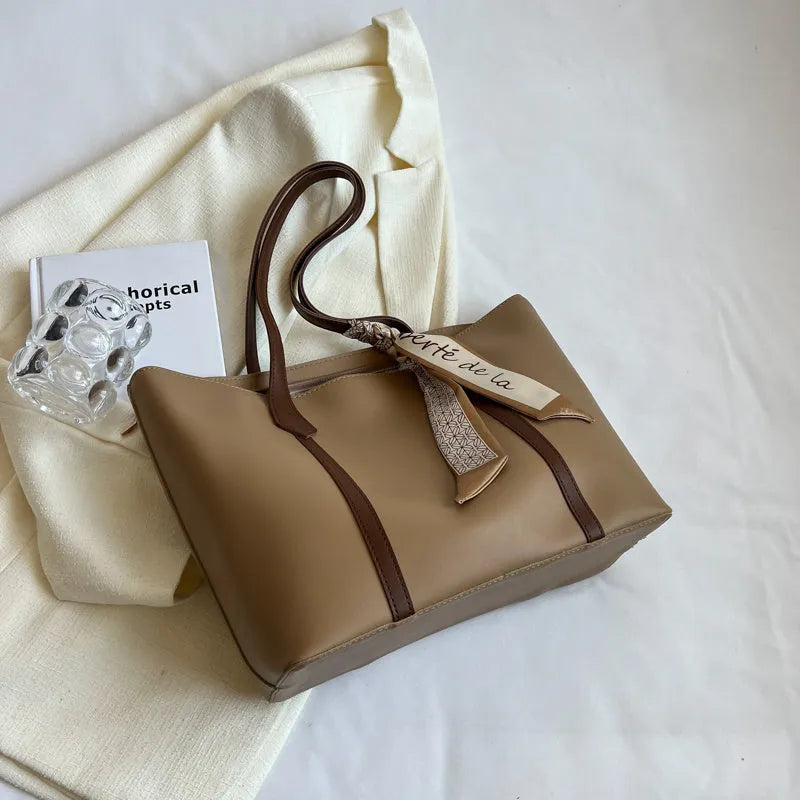 Women's large capacity soft tote bag with crossbody strap showing zipper compartment interior