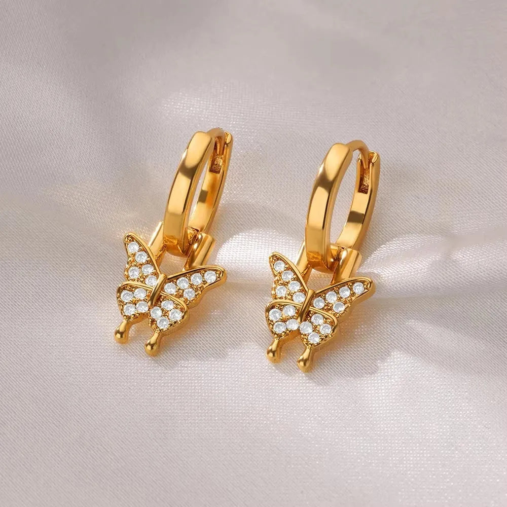 Geometric butterfly-shaped copper earrings for women with heart and star design details.