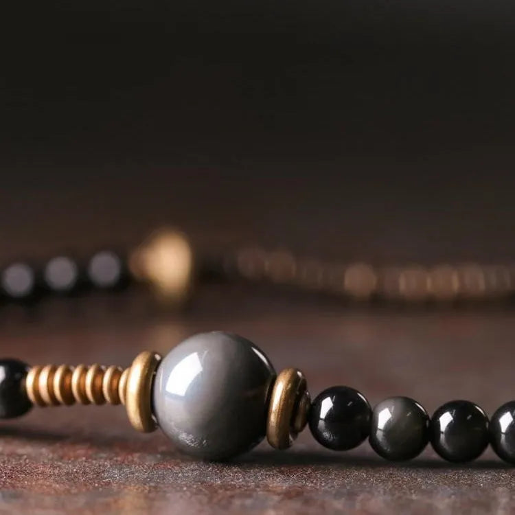 Unisex black beaded geometry multi-layered bracelet with natural style on plain background