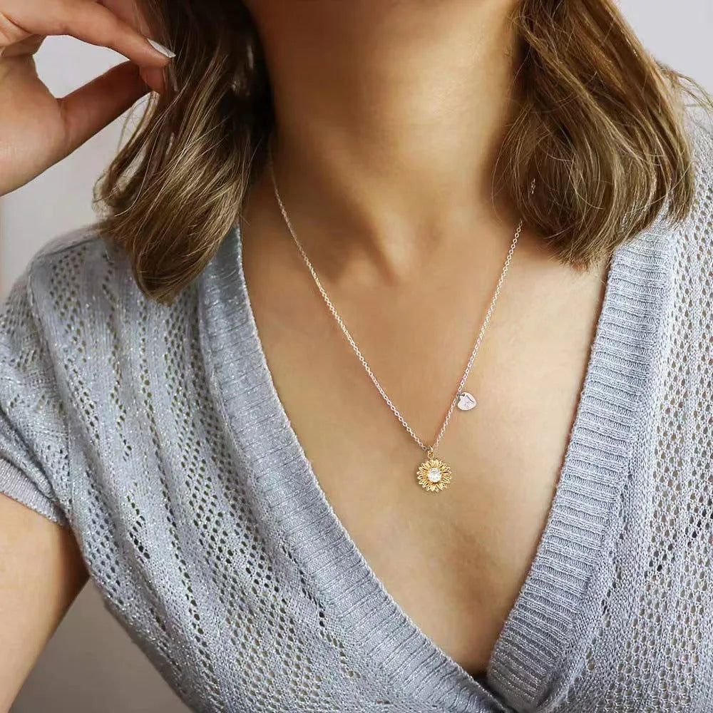 Women's sunflower-themed 925 silver pendant necklace with geometric petals on an adjustable cross chain.