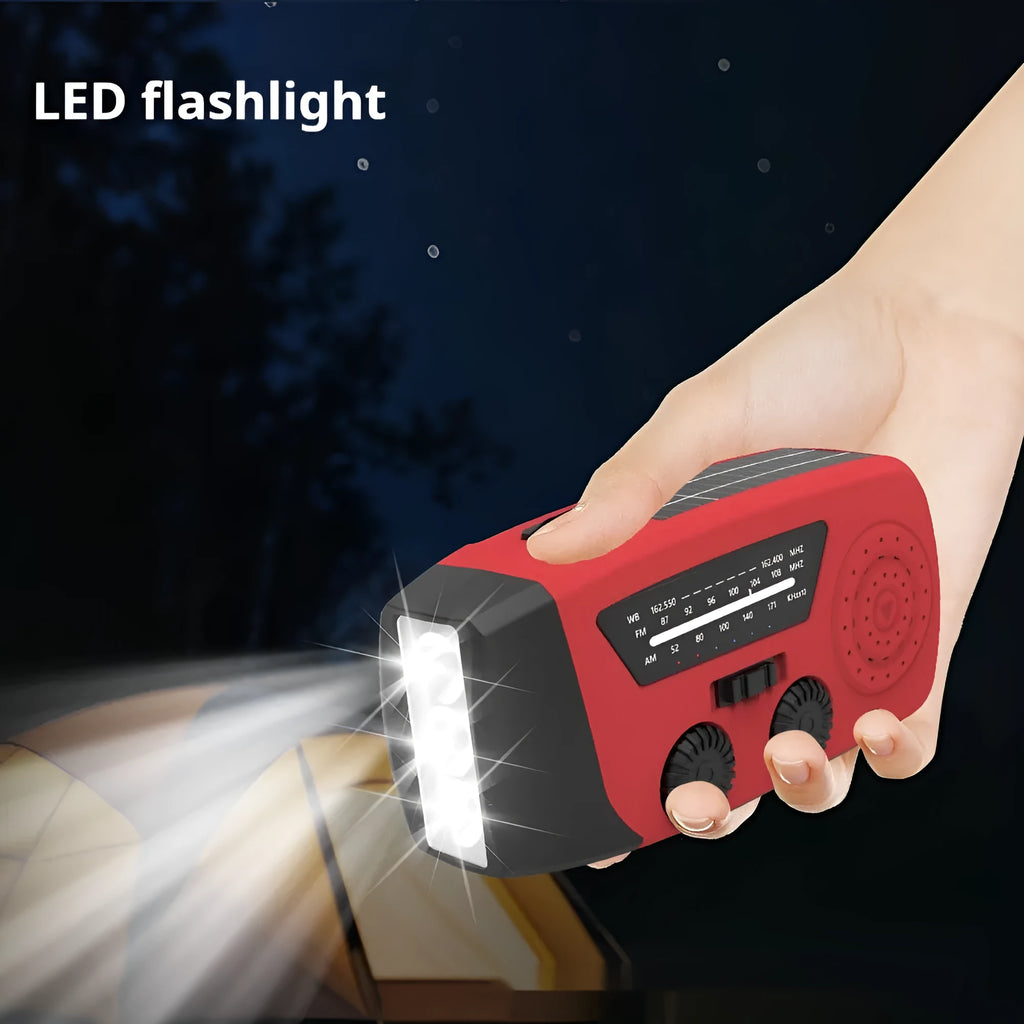 Red emergency rechargeable hand radio torch with wrist strap showing USB port and control buttons