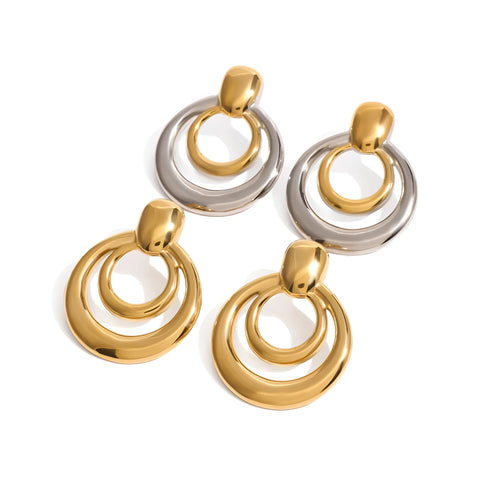 Round golden geometric hollow stud earrings made from titanium steel with an 18K gold electroplated finish.