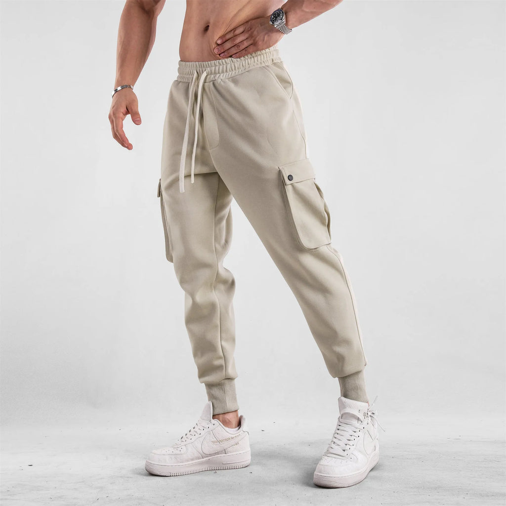 Men's loose cotton sports trousers with ankle tie detail and multiple pockets in apricot colour