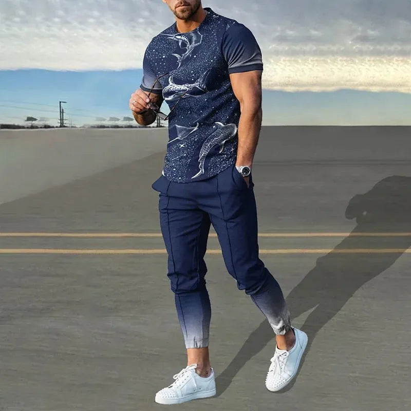 Man wearing a light grey short-sleeved pullover and matching trousers from a men's two-piece tracksuit set.