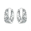 Pair of sterling silver hollow butterfly earrings with zircon accents, showing retro design.