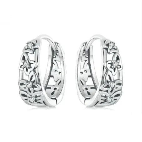 Pair of sterling silver hollow butterfly earrings with zircon accents, showing retro design.