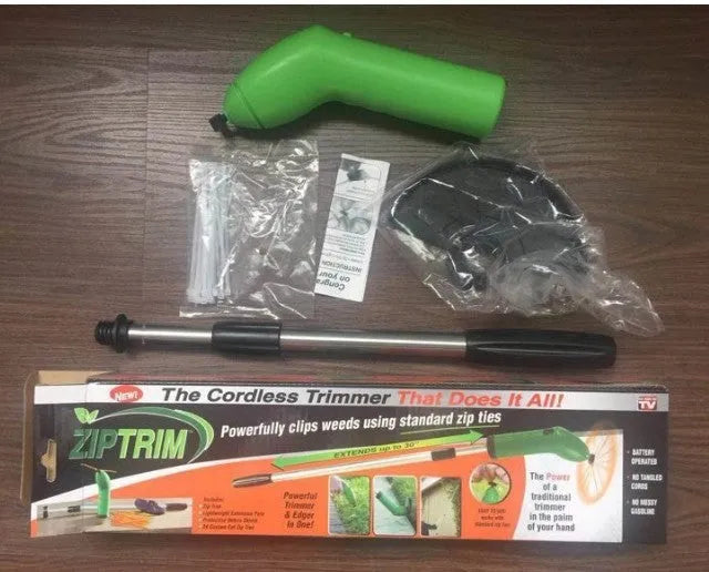 Cordless handheld zip trimmer with extension pole and debris shield on grass