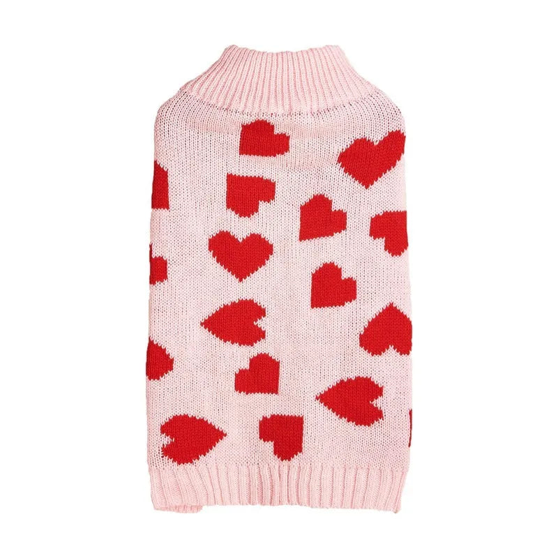 Dog wearing red love heart and pink bow decorated acrylic sweater