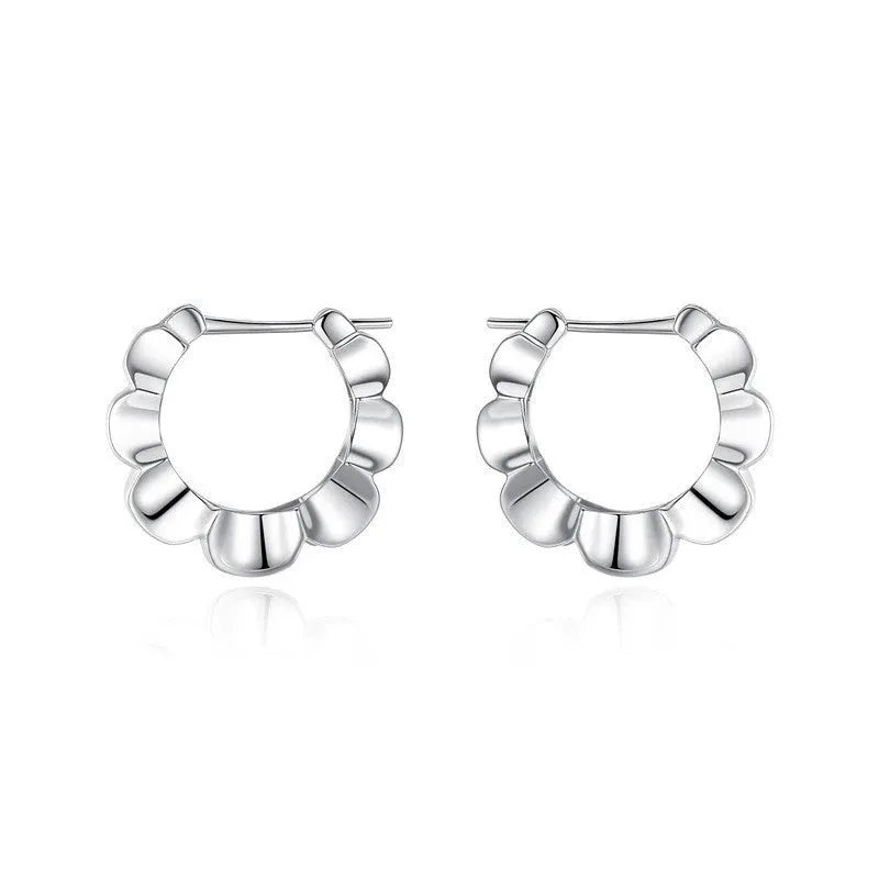 A pair of sterling silver geometric earrings with round details in a retro style.