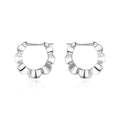 A pair of sterling silver geometric earrings with round details in a retro style.