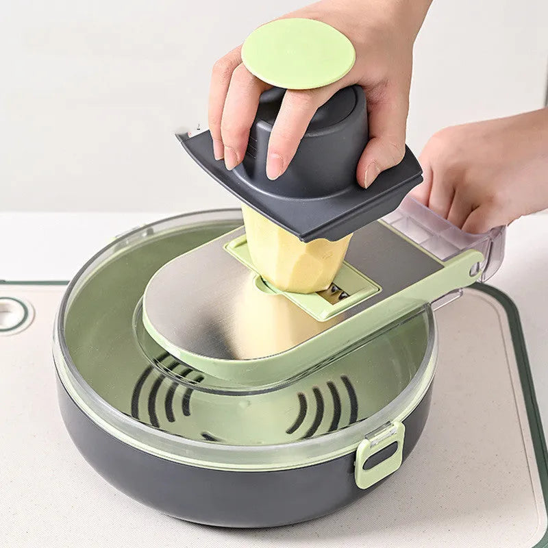 Grey multifunctional vegetable cutter with 8 knives in ABS and stainless steel, on a kitchen counter