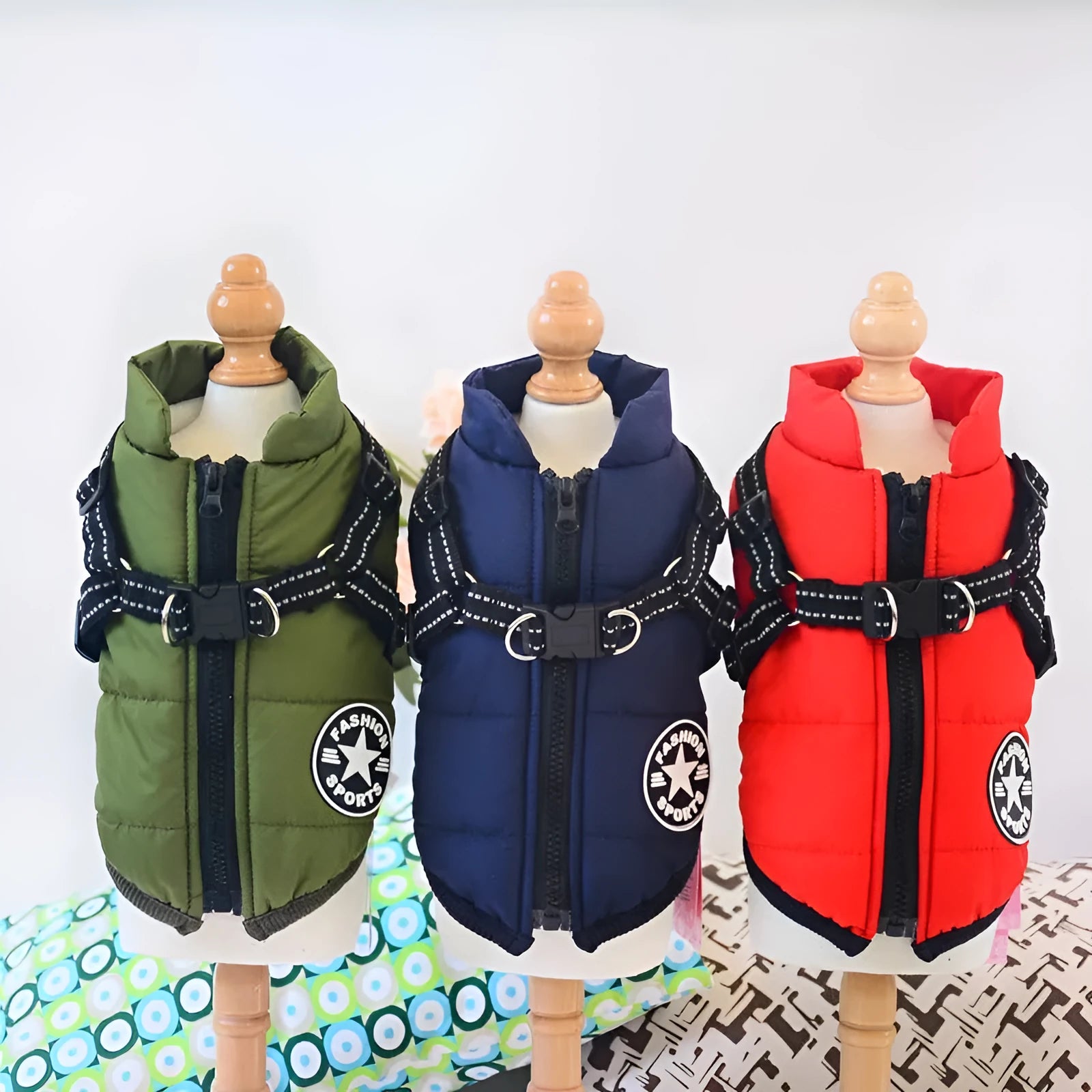 Waterproof dog coat in rain silk fabric with a harness hole, shown in red, navy blue, and army green.