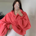 Watermelon red women's sleeveless hooded sweater in mulberry silk fabric on hanger