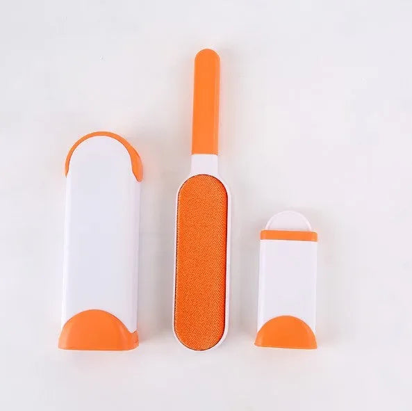 Blue self-cleaning pet hair removal brush for sofas on a grey fabric couch.