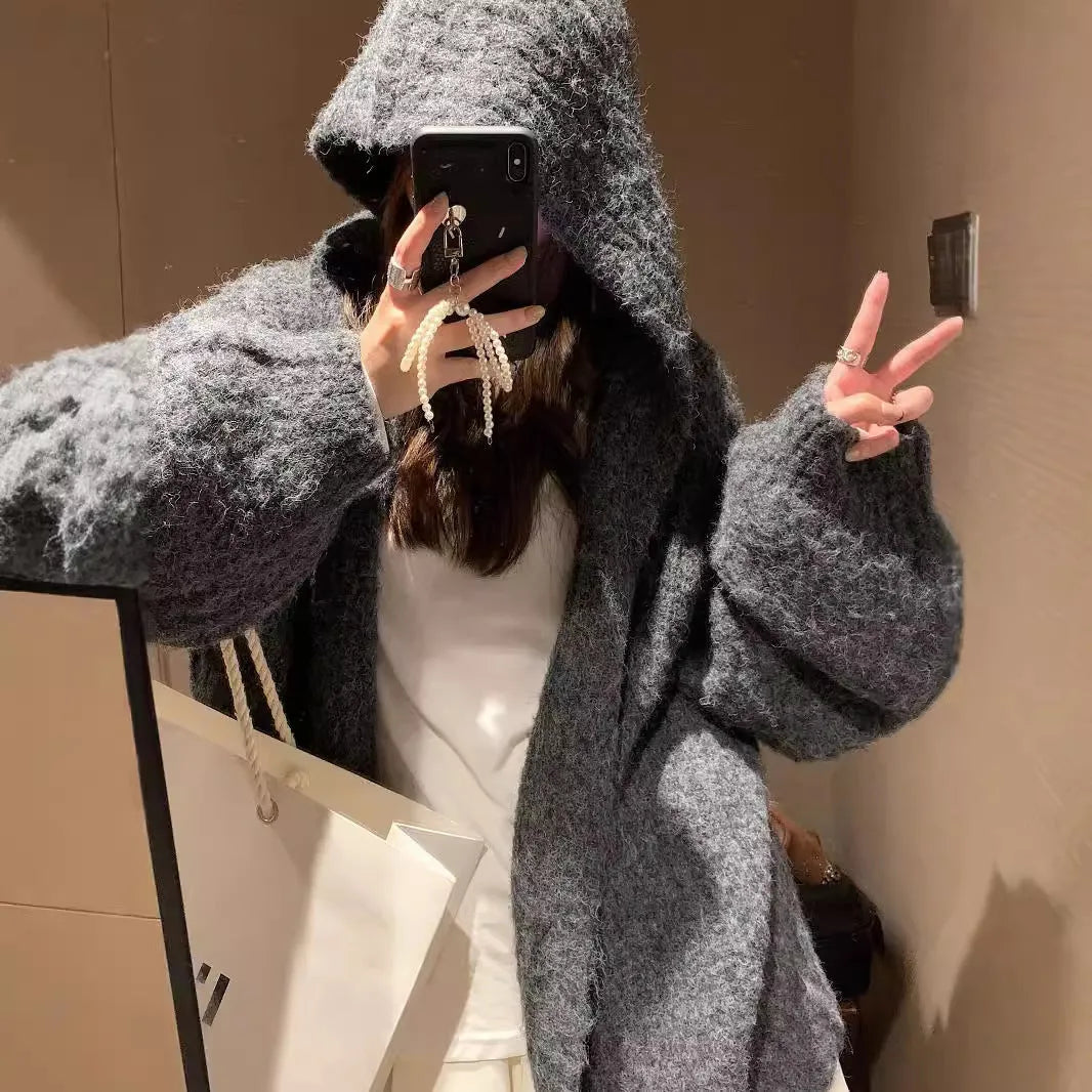 Women's dark grey loose-fit hooded cardigan sweater with chunky acrylic knit texture.
