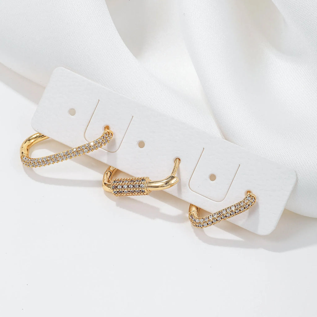 Three geometric earrings with micro inlaid zircon on square clips in gold and white finishes