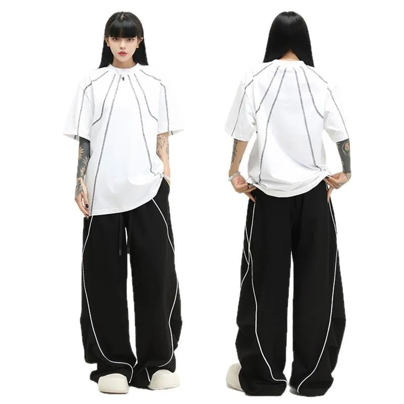 Black pleated wide-leg trousers with striped pattern showing mid-waist design and loose fit