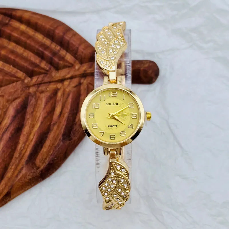 Stainless steel women's watch with round dial and vachette clasp, shown in gold, black, and white colour options.