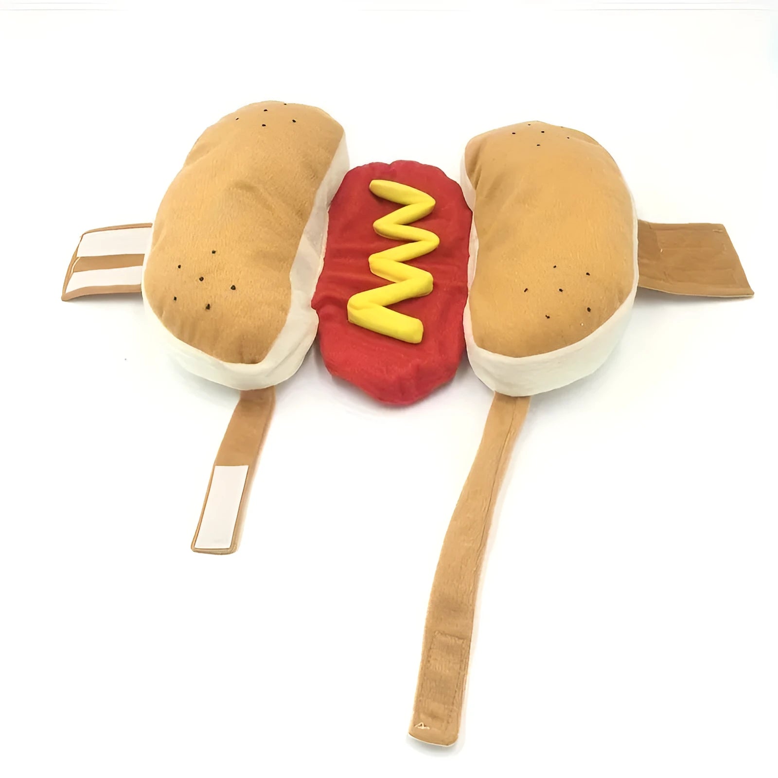 A small dog wearing a plush red and brown hot dog costume with elastic straps.