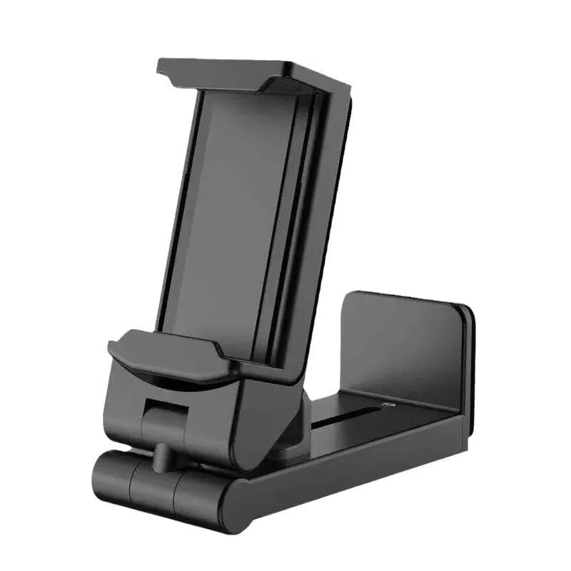 360 rotary collapsible mobile phone holder in black on a desk, with a phone propped up in landscape mode