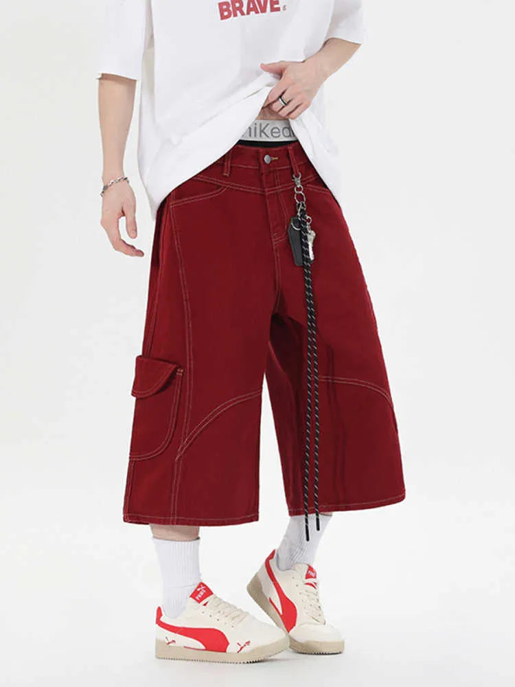 Women's retro denim shorts with multiple pockets in a wide-leg cropped style on a hanger.
