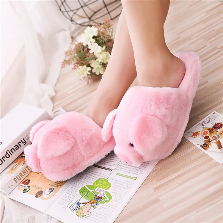 Pink pig floor slippers with plush lining shown on clean indoor surface