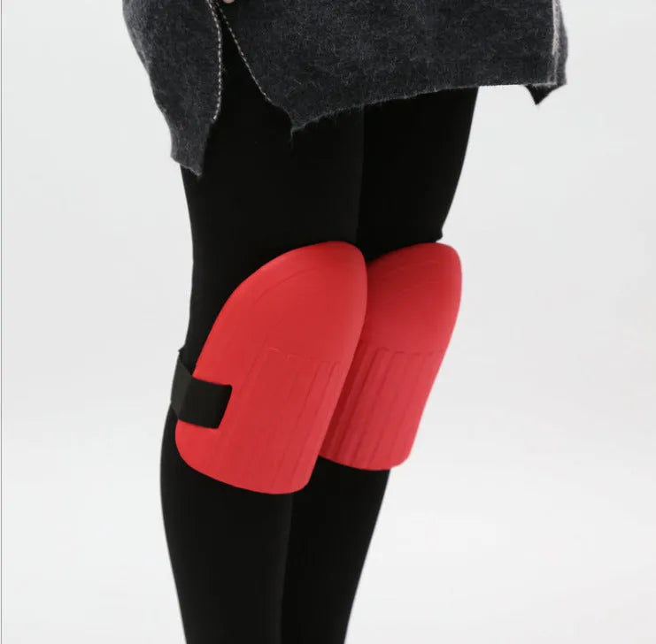 A pair of black EVA foam knee pads for gardening, showing their rectangular shape and thickness.