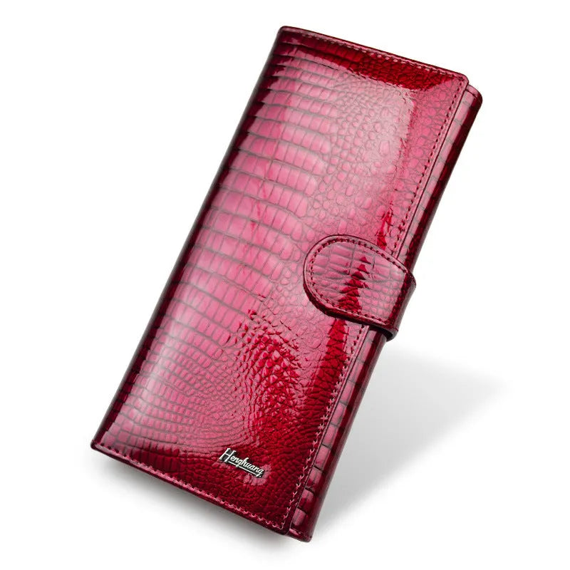 Women's patent leather coin purse with crocodile pattern in red colour showing pigskin lining interior