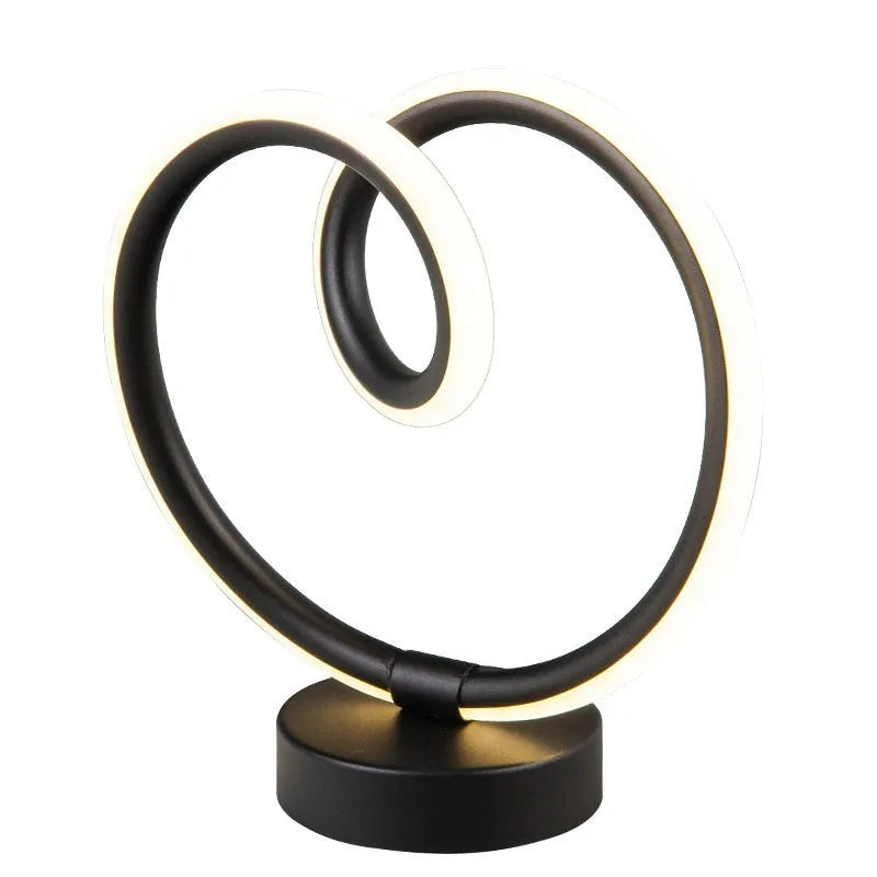 Black musical note shaped Bluetooth LED lamp with RGB colour changing lights on a table.