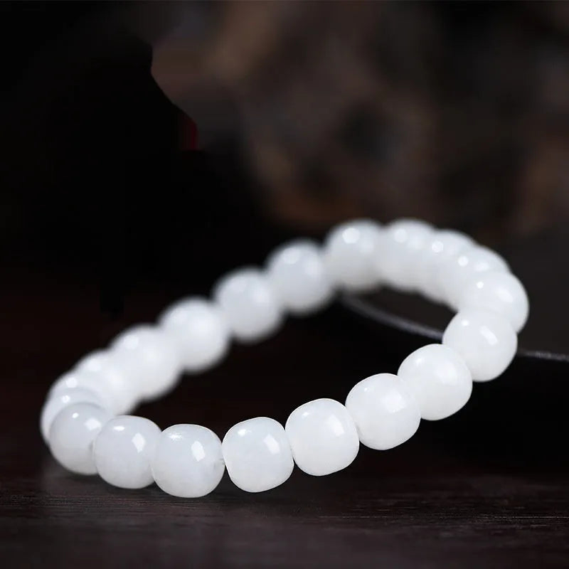 White Hetian jade barrel bead bracelet shown on a wrist, showcasing its unisex casual style.