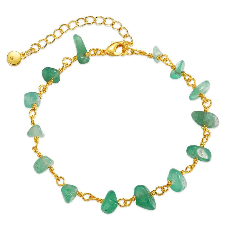 Women's copper bracelet with irregular natural gravel stones and turquoise crystals in geometric design.