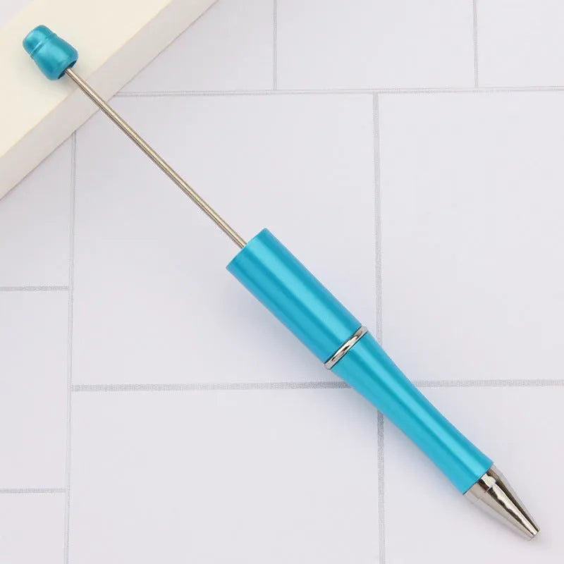 Creative plastic beaded ballpoint pen with spinning coloured beads around barrel in various colour options