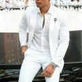 Men's white slim fit two-piece wedding suit jacket and trousers on a hanger.
