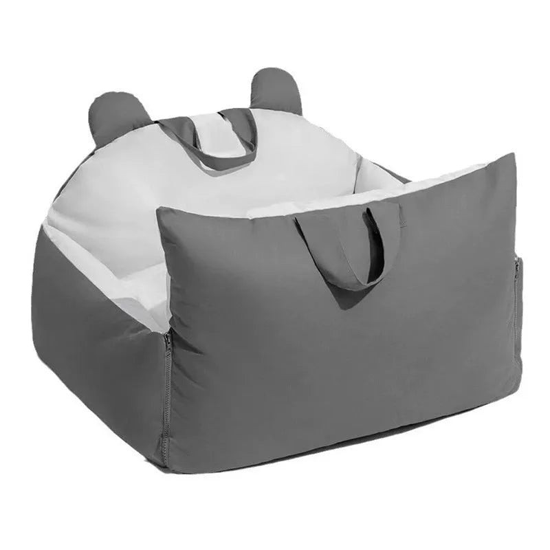 A removable washable dog car kennel in a beige colour, shown in a vehicle boot.