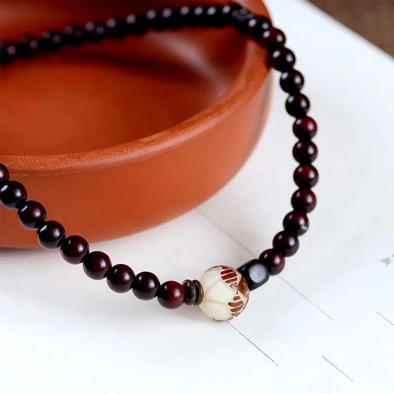 Natural rosewood knitted unisex bracelet with 10mm flower-shaped beads double circle on white background
