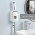 Automatic toothpaste dispenser unit in blue, grey, and pink colours made from ABS plastic.