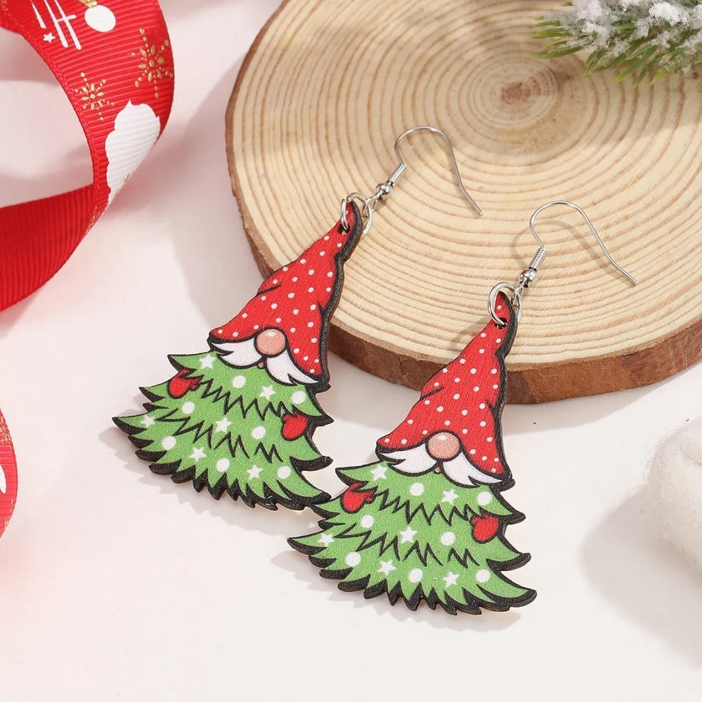 Women's wooden Christmas earrings with printed tree and snowman designs on geometric shapes.
