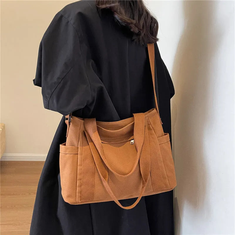 Women's polyester canvas shoulder tote bag in solid colour with exterior sandwich pocket