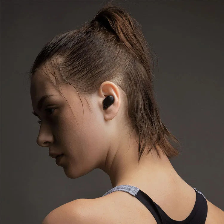 Redmi AirDots black true wireless earbuds and their compact charging case on a white background.