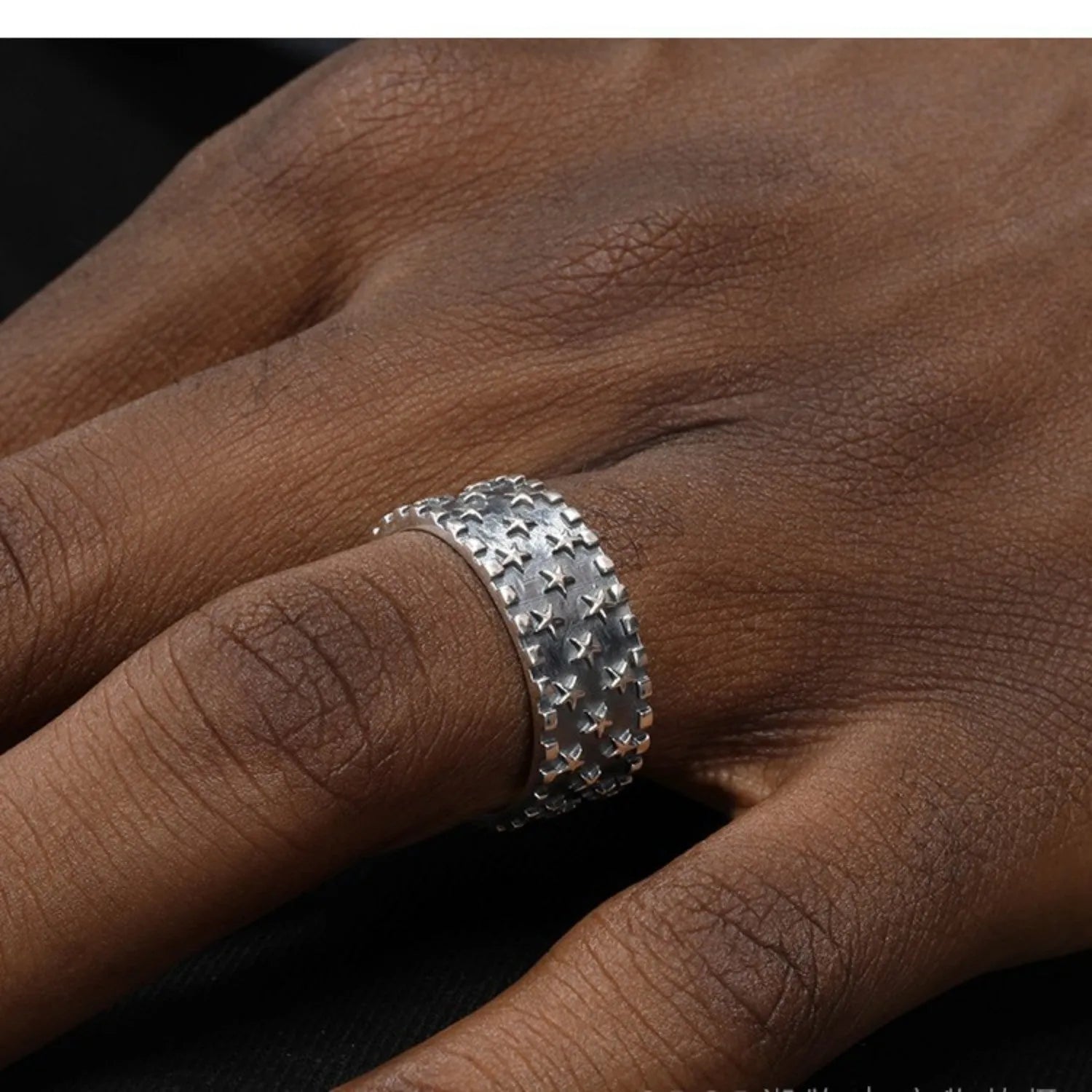Adjustable open band sterling silver ring with a geometric five-pointed star design.