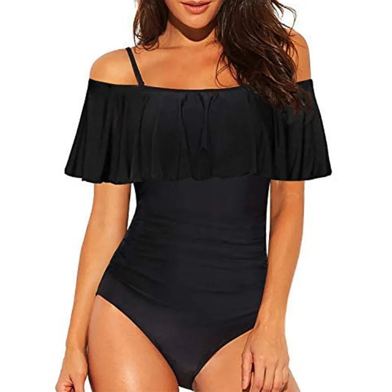 Black strapless one-piece swimsuit with side cut-out details and ruffled shoulder straps.
