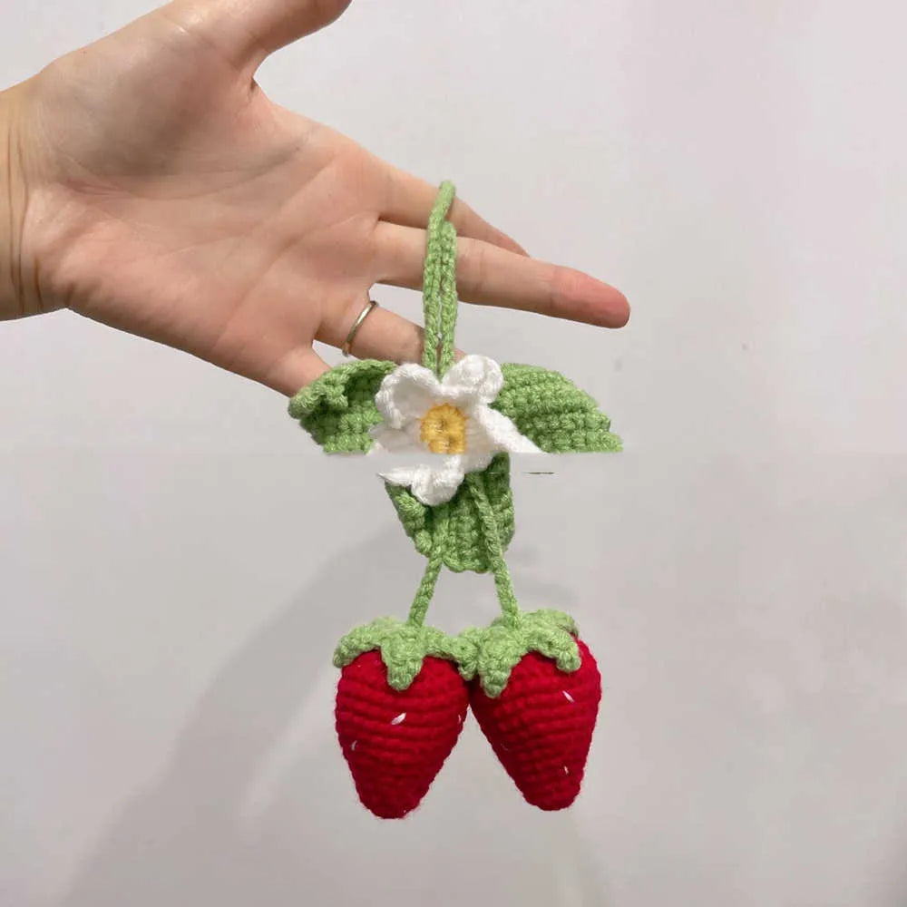 Handwoven strawberry-shaped car pendant made from natural cotton and hemp fibres.