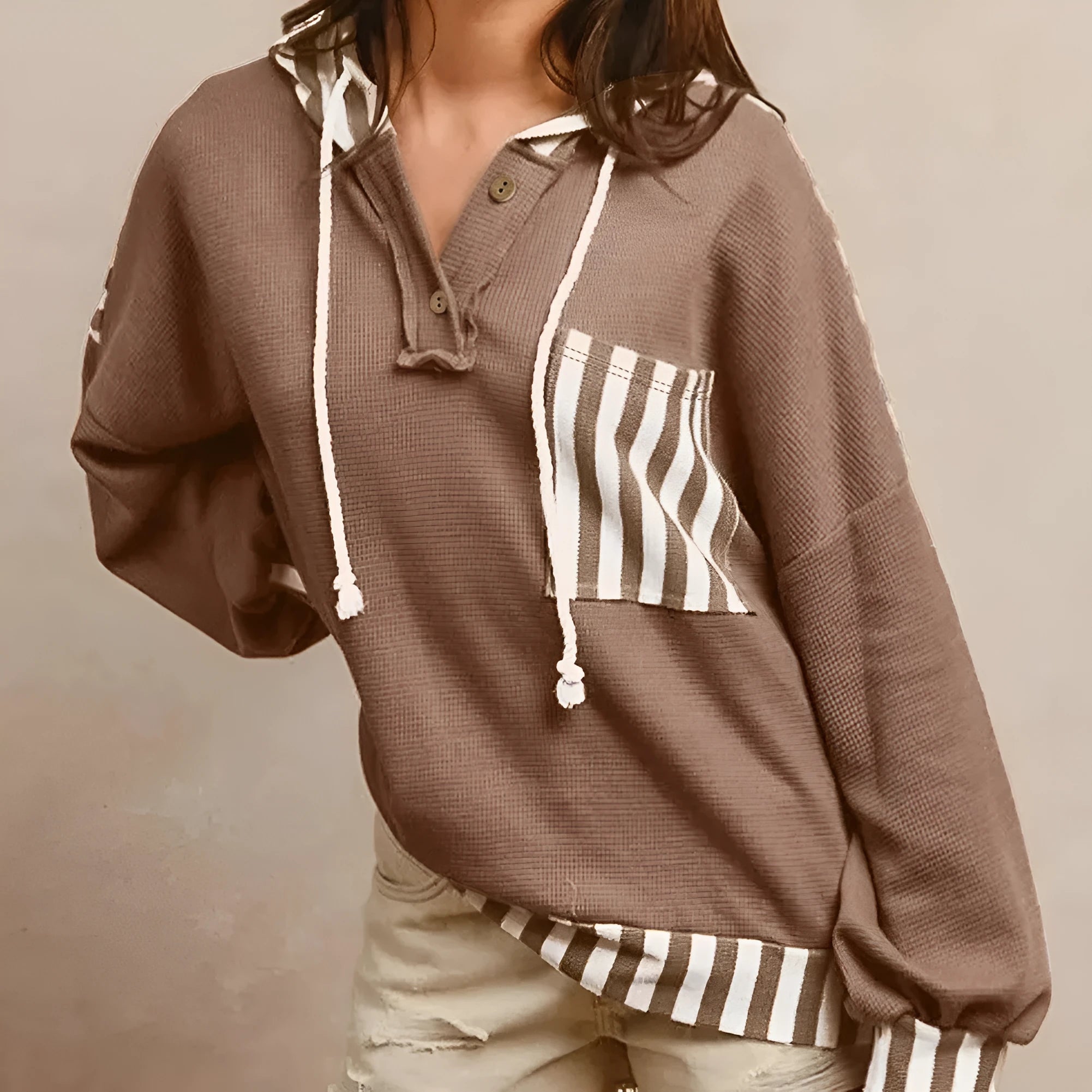 Straw yellow long sleeve hoodie with waffle texture, striped patchwork, button neck, and drawstring hood.